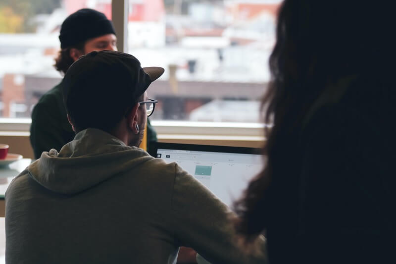 a man sitting in a busy surroundings, checking his calendar