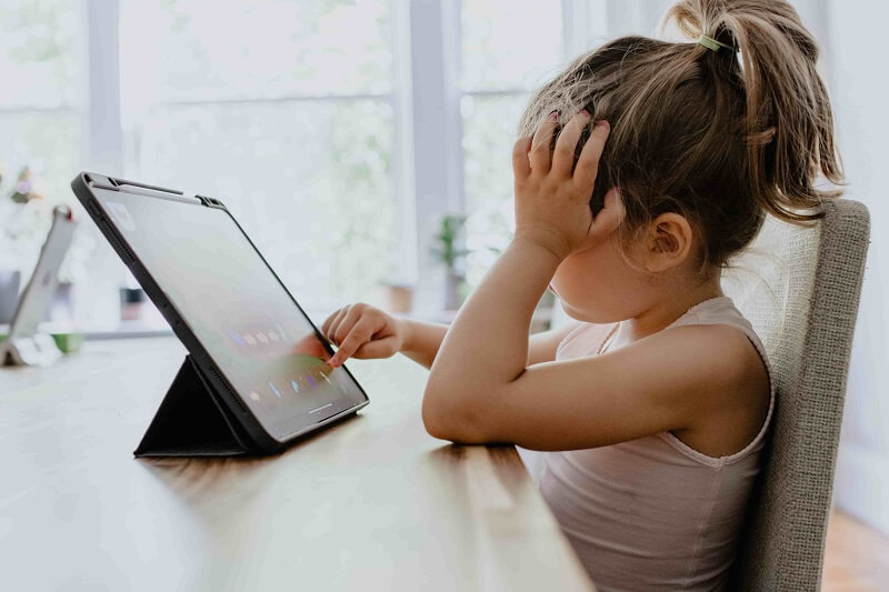 a child is using a tab, the concept of family office cybersecurity