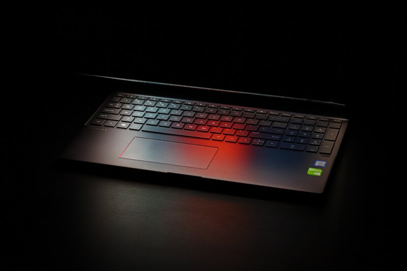 laptop with red light; the concept of passwords on the dark web